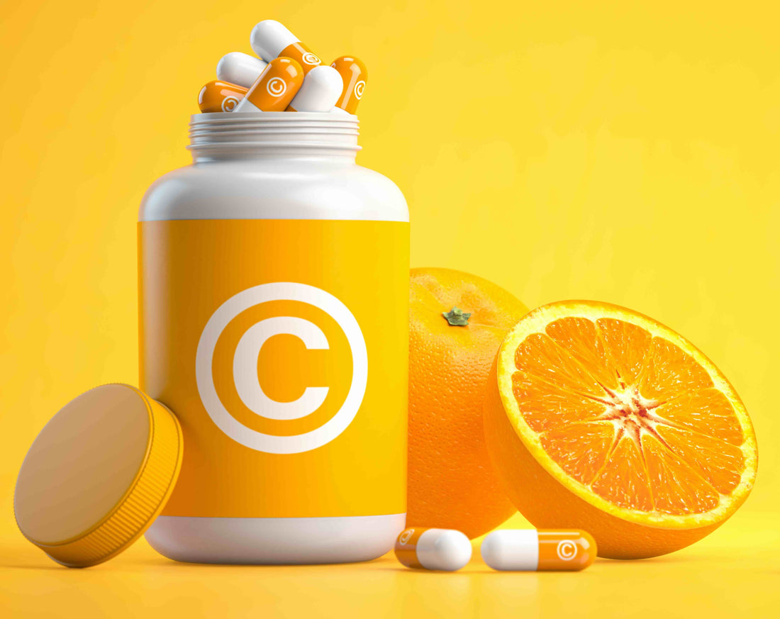 A photo of vitamin c supplements surrounded by oranges.