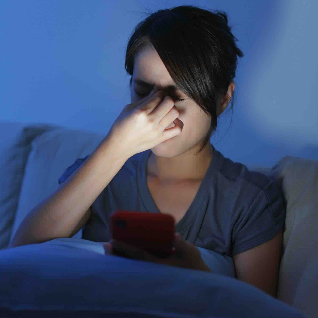 A photo of a woman suffering from eye damage due to blue light exposure.